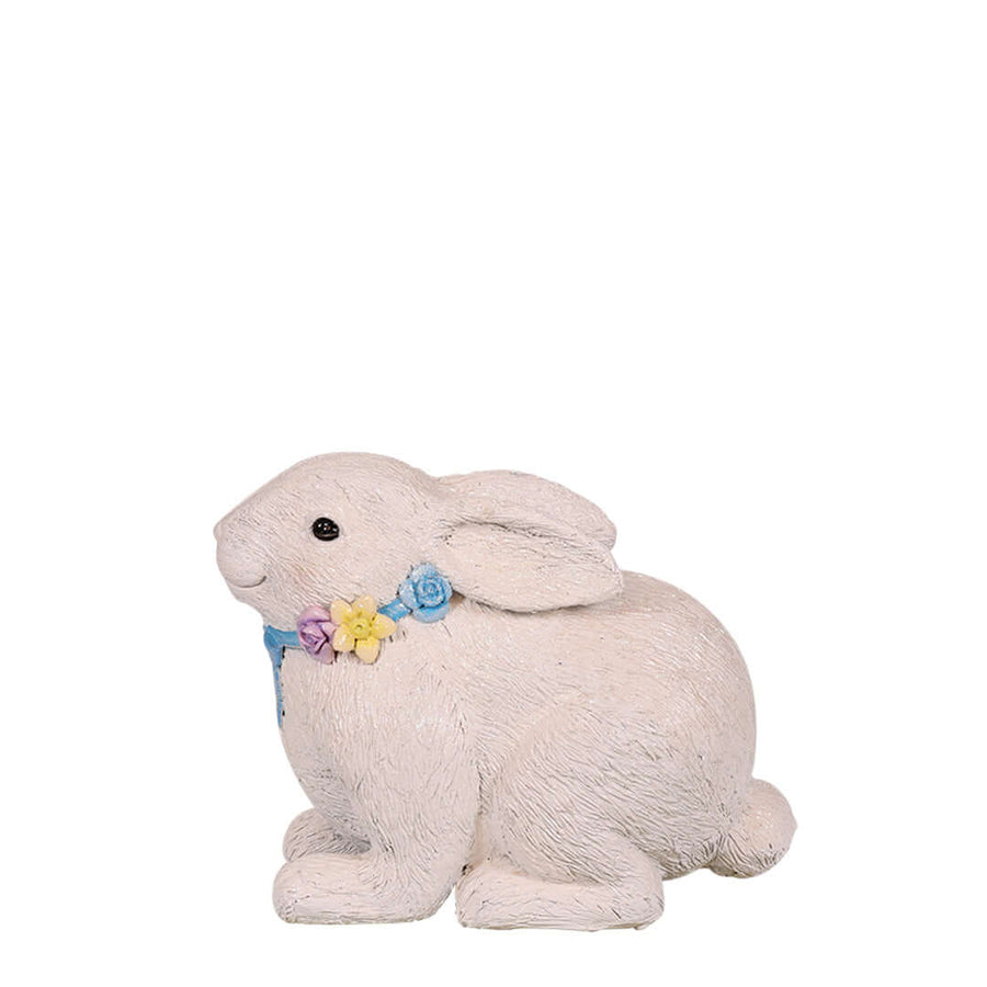 easter rabbit lying down while heads up with flower necklace