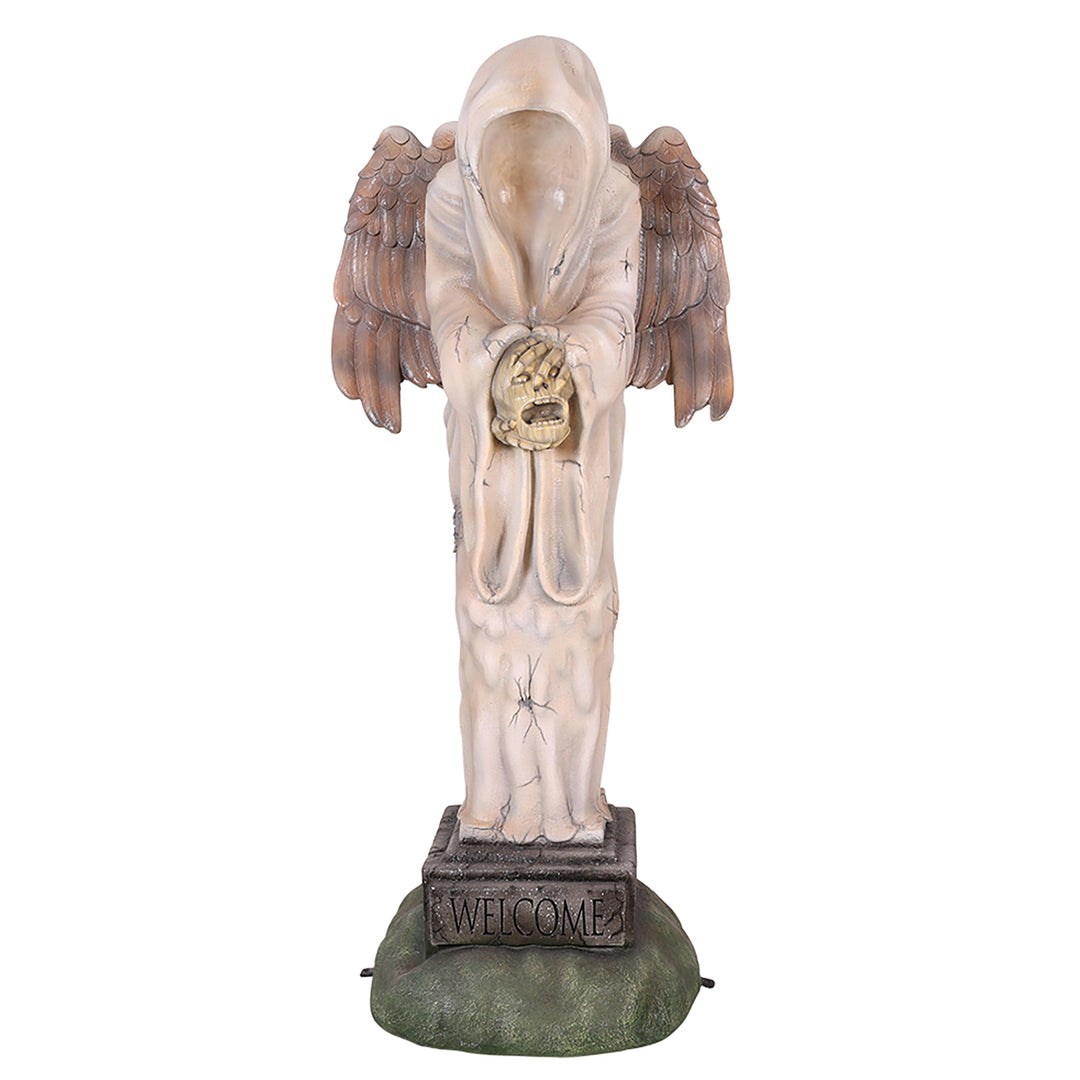 A faceless angel  statue holding a human head facing front