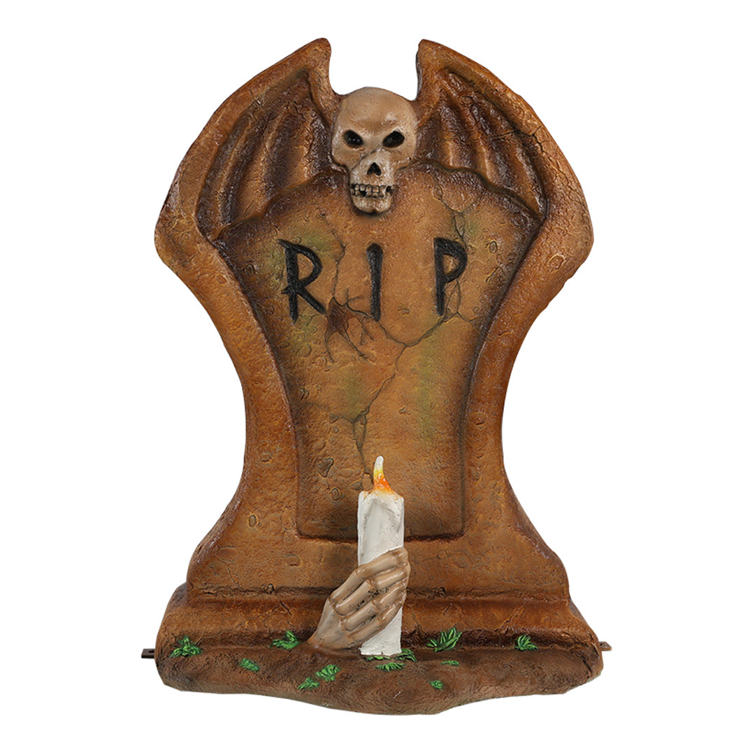 A gravestone with a candle front view