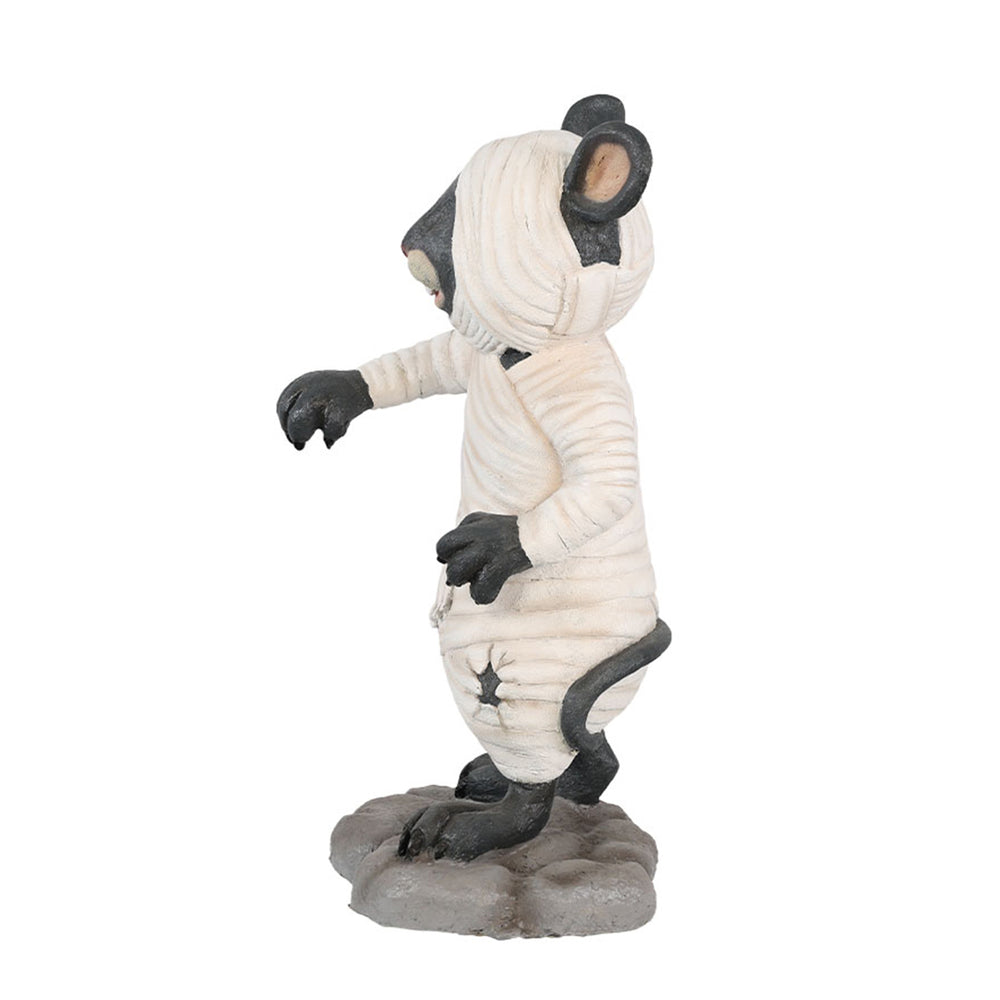 A mouse dressed as a mummy side view