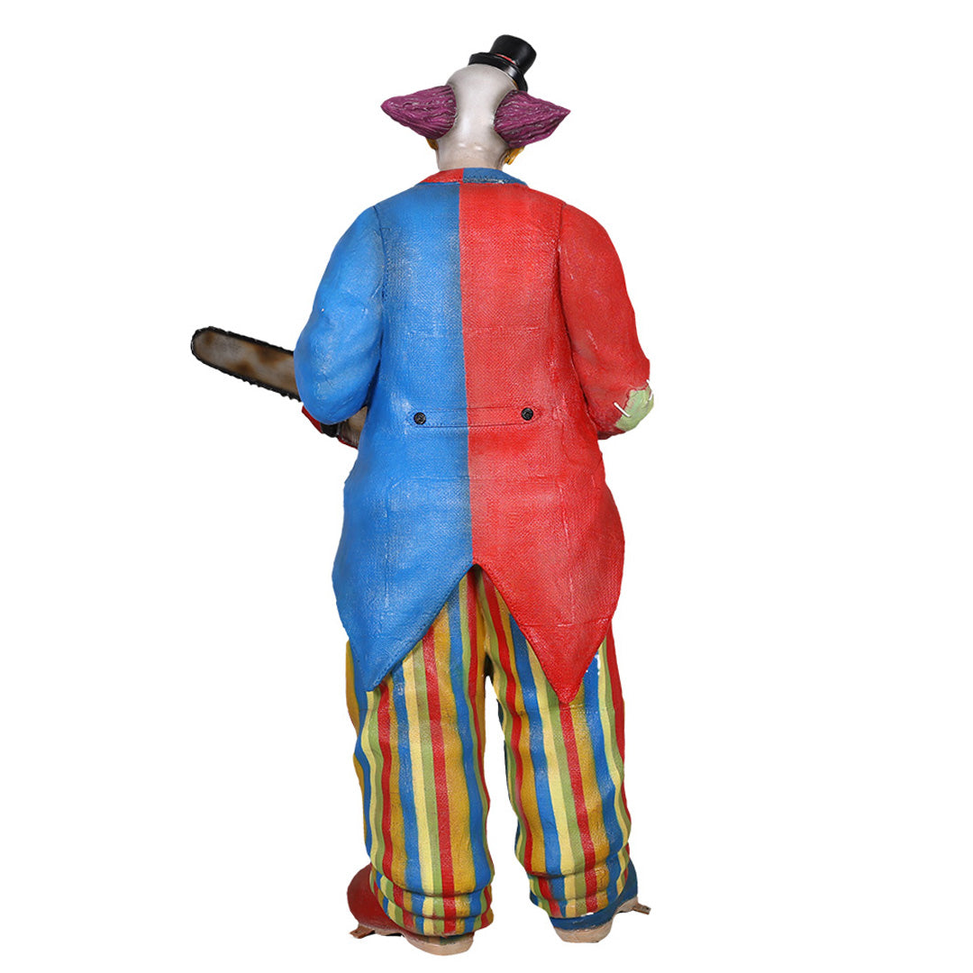 A scary clown holding a chainsaw facing back