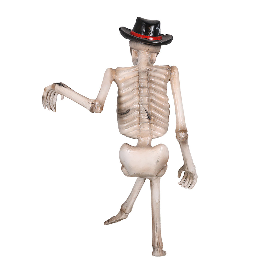 A skeleton sitting on a bench wearing a hat back view