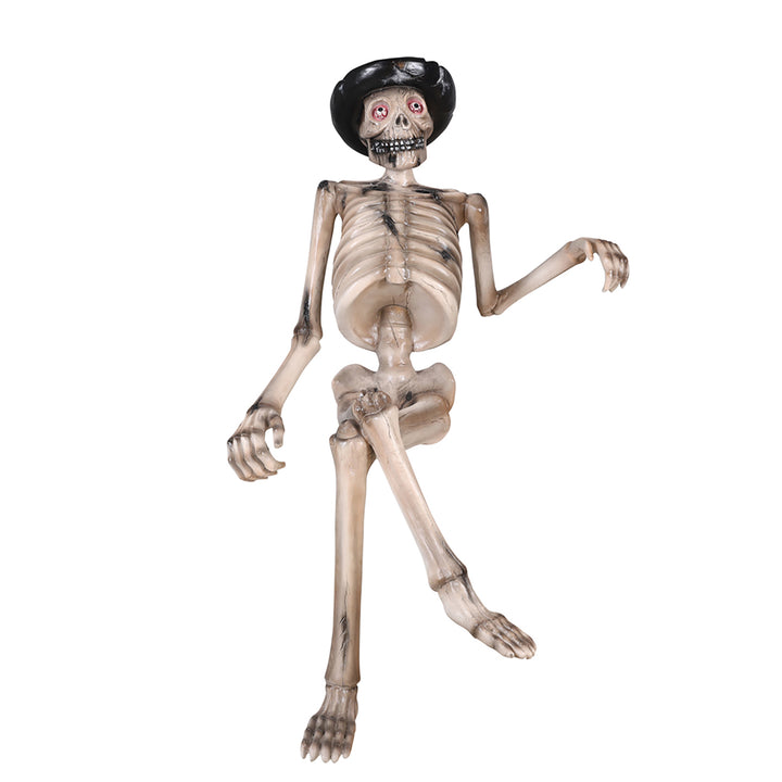 A skeleton sitting on a bench wearing a hat front view